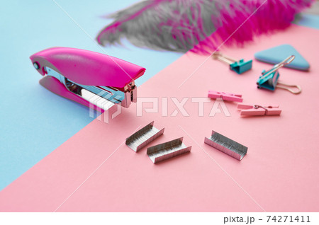 Stapler and clips closeup, blue background 74271411