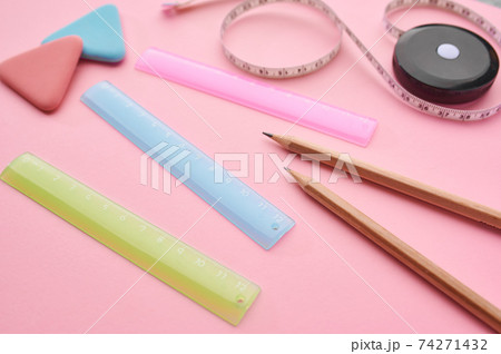 Stationery supplies closeup, pink background Stationery supplies closeup, pink background 74271432