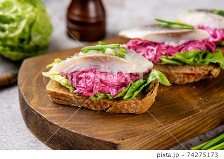 Herring sandwich with beet and green salad 74275173