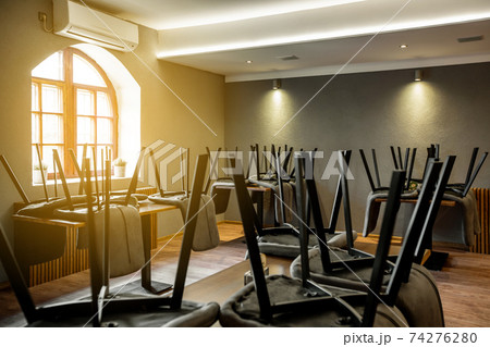 View to closed restaurant or pub without people during coronavirus pandemic, covid-19, lockdown concept, economic crisis View to closed restaurant or pub without people during coronavirus pandemic, covid-19, lockdown concept, economic crisis 74276280