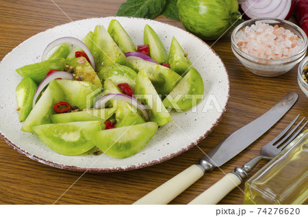 Appetizer of spicy pickled green tomatoes Appetizer of spicy pickled green tomatoes 74276620