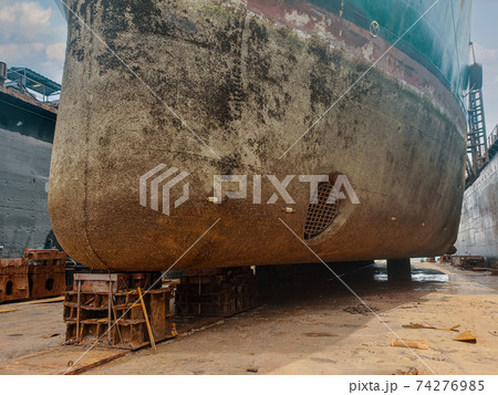 Industry view - Ocean Vessel in the dry dock in shipyard. Old rusty ship under repair Industry view - Ocean Vessel in the dry dock in shipyard. Old rusty ship under repair 74276985