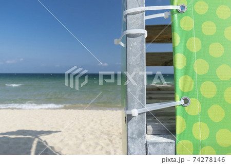 Beach umbrella against the blue clear sky on the beach 74278146