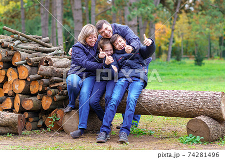 family relaxing outdoor in autumn city park, happy people together, parents and children, they playing, talking and smiling, beautiful nature family relaxing outdoor in autumn city park, happy people together, parents and children, they playing, talking and smiling, beautiful nature 74281496