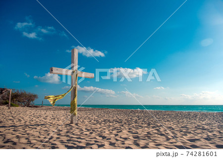 Wooden cross on the beach of the Caribbean Sea 74281601