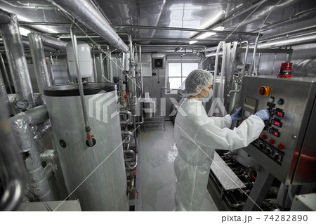 Female Worker Wearing Protective Suit at Factory Female Worker Wearing Protective Suit at Factory 74282890