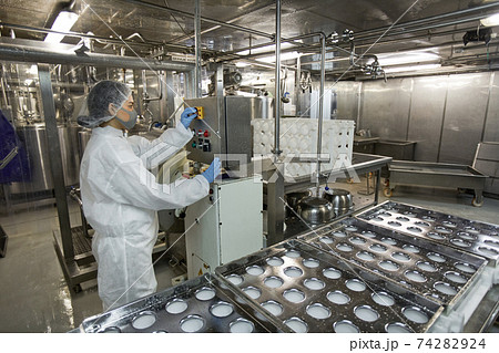 Female Worker Operating Conveyor at Food Factory 74282924