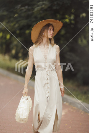 Woman with Flowers in Nature in the Summer. Woman with Flowers in Nature in the Summer. 74283291