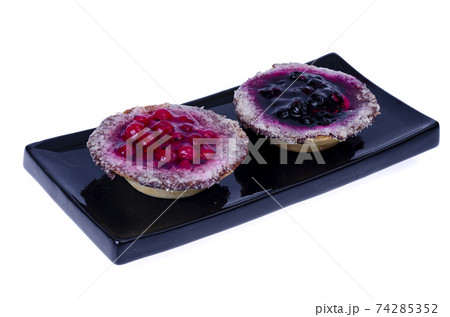 Sand baskets with sweet berries and jelly on white background. Studio Photo 74285352