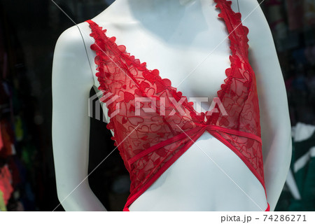 closeup of red bra with little hearts on mannequin in a fashion store showroom closeup of red bra with little hearts on mannequin in a fashion store showroom 74286271