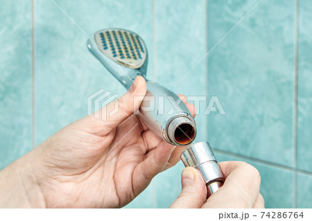 Rust inside old shower head being disassembled. Rust inside old shower head being disassembled. 74286764