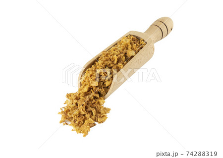 Crispy fried onion flakes in wooden scoop 74288319