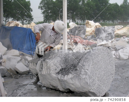 worker is carving stone into crafts worker is carving stone into crafts 74290858