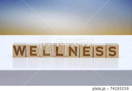 'Wellness' message sign on wooden blocks sitting on a white table. 'Wellness' message sign on wooden blocks sitting on a white table. 74293259