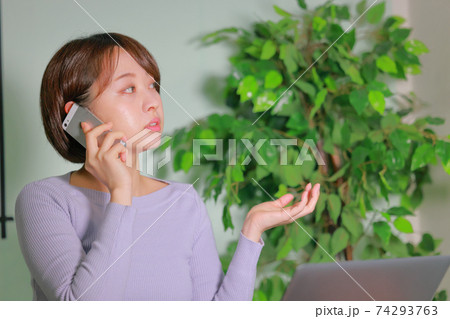 思い出しながら電話で話すテレワークの女性 思い出しながら電話で話すテレワークの女性 74293763