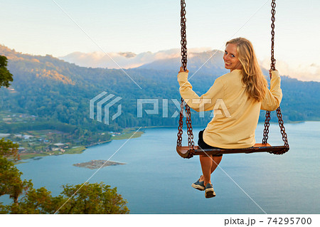 Young woman looking at amazing tropical lake in mountains Young woman looking at amazing tropical lake in mountains 74295700