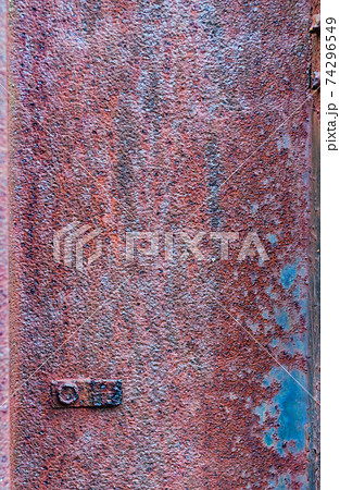 Rusty metal surface, not painted, oxidized rough texture, brown rust with peeling blue paint, outdoors 74296549