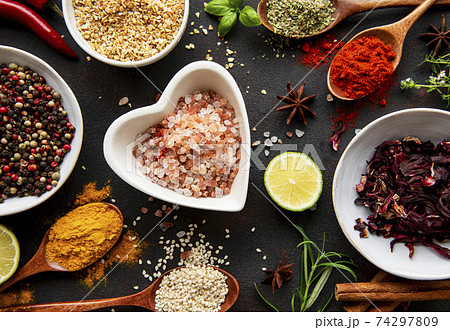 Colorful and aromatic herbs and spices on a dark background 74297809