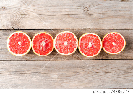 Overhead shot of juicy grapefruits on wooden table Overhead shot of juicy grapefruits on wooden table 74306273
