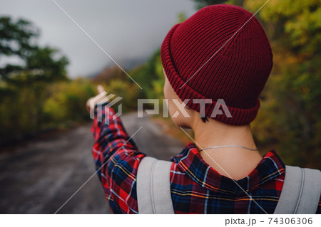 Happy Asian girl backpack in road and forest background 74306306