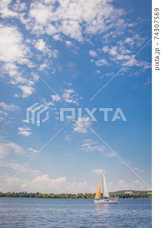 Yacht on a clear sunny day on the blue water of the river. 74307569
