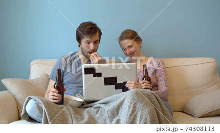 Family drinking beer on the couch 74308113