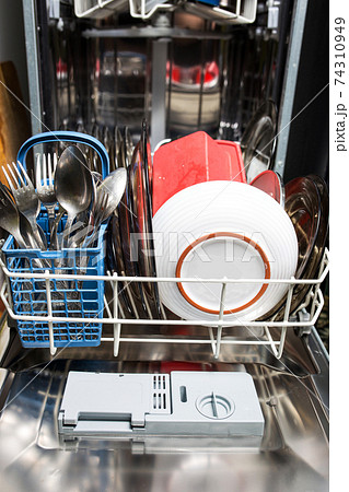 Dishwasher with dirty dishes closeup. Household kitchen appliances. Assistant hostess. 74310949