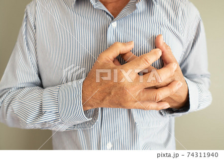 Heart attack problems. Elderly man suffering from severe chest pain. Warning signs of unstable angina or myocardrial infarction disease. Health care and cardiological concept. Close up. 74311940