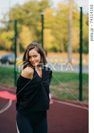Beautiful young woman on the playground looking at the camera 74314168