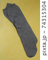 Gray socks on an isolated yellow background 74315304