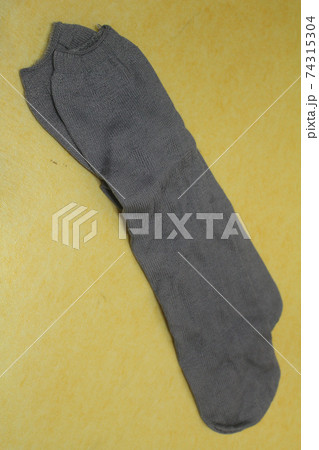 Gray socks on an isolated yellow background Gray socks on an isolated yellow background 74315304