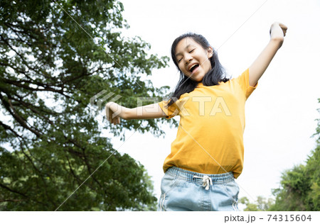 Happiness asian woman standing feel comfortable at park,smiling female teenage with stretching her arms,enjoy breathing fresh air,freedom and relaxing in green nature after school,lifestyle concept Happiness asian woman standing feel comfortable at park,smiling female teenage with stretching her arms,enjoy breathing fresh air,freedom and relaxing in green nature after school,lifestyle concept 74315604