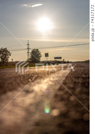 A long white stripe, like a road marker. A road between fields 74317172