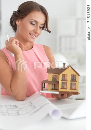 Beautiful female architect working in modern office Beautiful female architect working in modern office 74318928