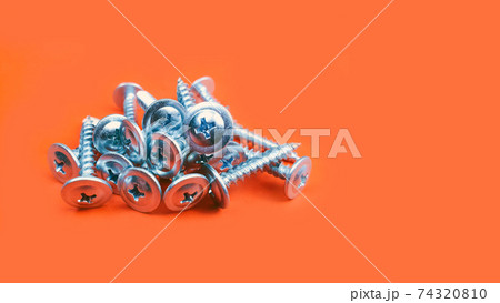 screws a lot, macro photo. Long Iron or metal screw nails on red backgraund. Front view, copy space screws a lot, macro photo. Long Iron or metal screw nails on red backgraund. Front view, copy space 74320810