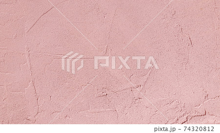 Pink decorative plaster on wall. Texture of rough stucco wall background, soft texture cement wall 74320812