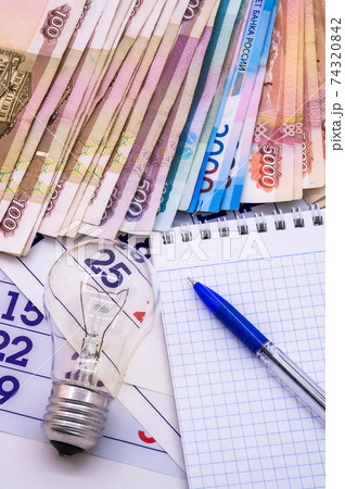 calendar 2021 and money, money and light bulb, calendar and Notepad with pen 74320842