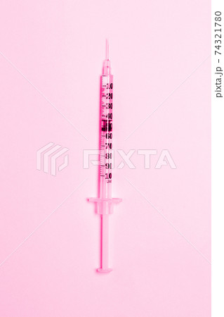 Medical syringe on a pink background. Health and vaccination concept. Cosmetology.Flat lay, copy space. Medical syringe on a pink background. Health and vaccination concept. Cosmetology.Flat lay, copy space. 74321780