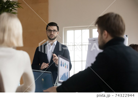 Business leader presenting project to colleagues or partners 74322944