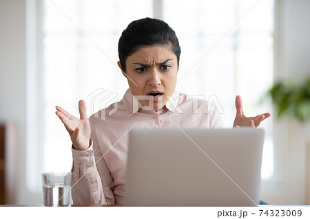 Shocked worried female employee getting unexpected bad news 74323009