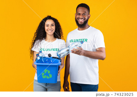 Two Volunteers Holding Box Full Of Plastic Bottles In Studio 74323025