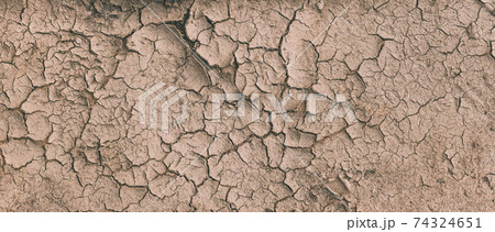 Background Of Brown Dry Cracked Soil Dirt Or Earth During Drought. Dry Cracked Earth Depicting Severe Drought Conditions. Panorama 74324651