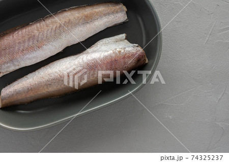 Two raw hake carcasses close-up 74325237