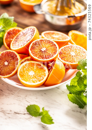 Blood sicilian oranges sliced on white plate with 74325569