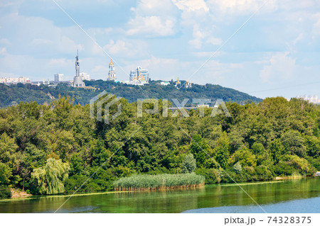 Beautiful summer landscape of the Dnipro islands to the Kyiv hills and the Pechersk Lavra on the horizon. 74328375