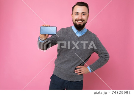Positive smiling Handsome happy cool young brunette unshaven man with beardwearing stylish grey 74329992