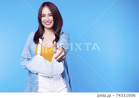 Insurance accident concept. Patient young woman wearing soft splint armband form accident Insurance accident concept. Patient young woman wearing soft splint armband form accident 74331006