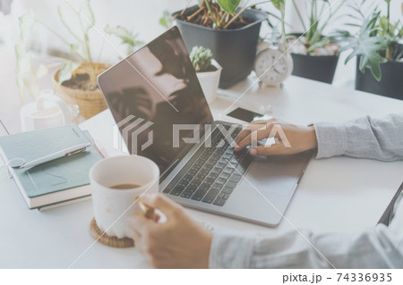 Woman is working on clean nature workspace at home with laptop, planner notebook and calculator. Business finance office. Woman is working on clean nature workspace at home with laptop, planner notebook and calculator. Business finance office. 74336935
