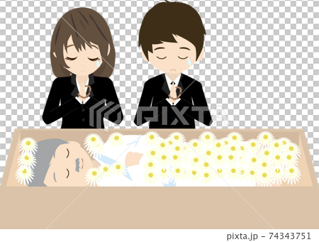 Bereaved family praying for the deceased with flowers 74343751