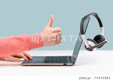 Laptop with headphones on white desk Laptop with headphones on white desk 74343983